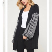 Brushed knit cardigan featuring an open front draped silhouette, dropped shoulders, and a super cute woven puff sleeve in black color